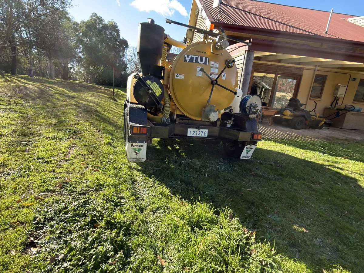 GreenVac compact vacuum trailer set up beside a house